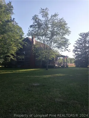 a view of a field of grass and trees