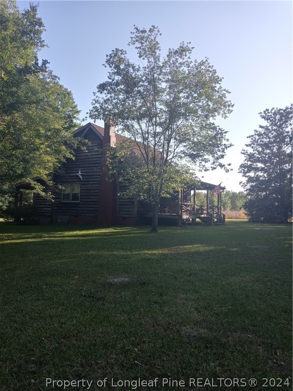 a view of a field of grass and trees