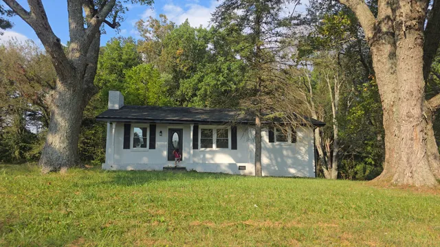 a front view of house with yard and trees