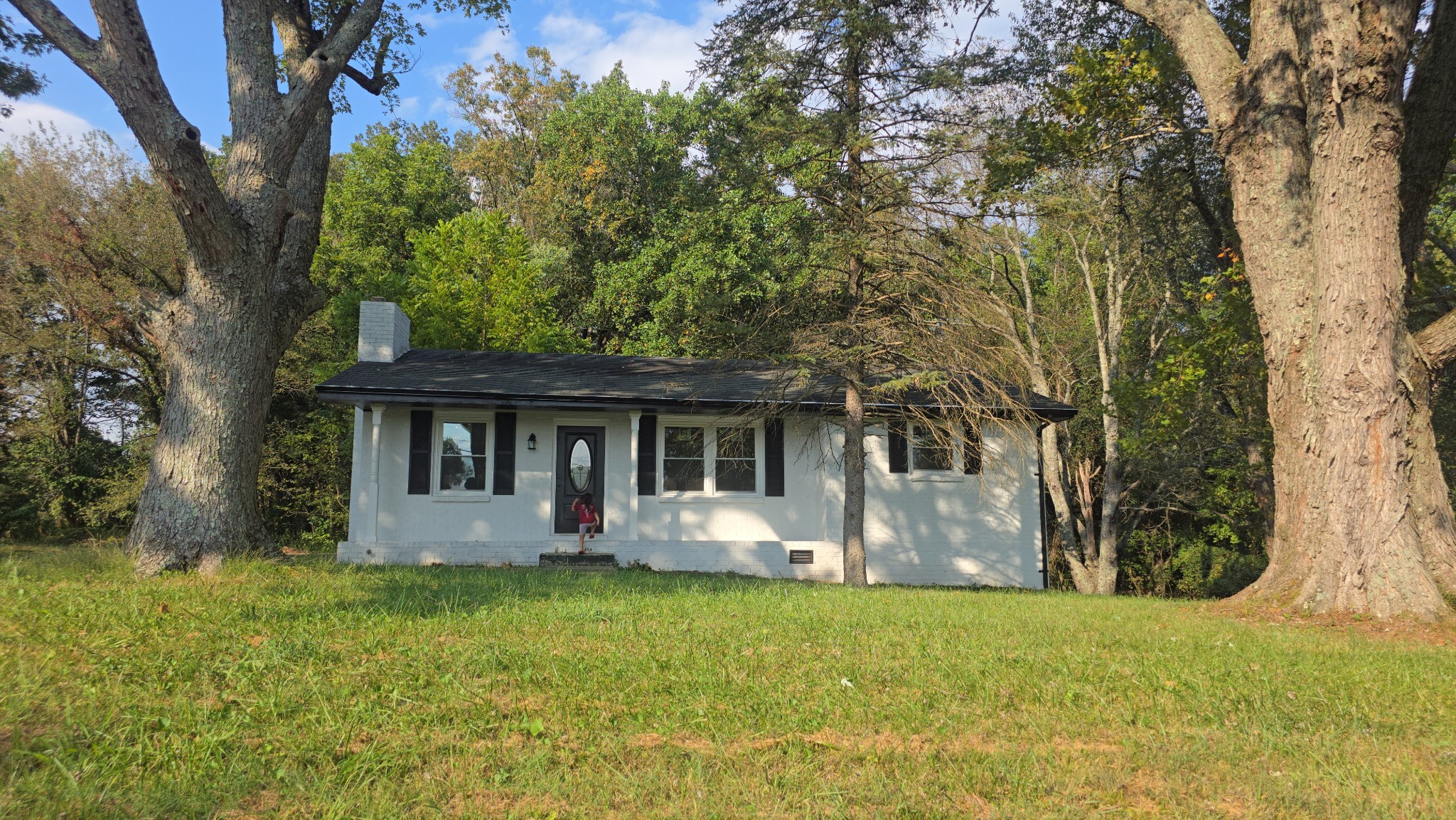 a front view of house with yard and trees