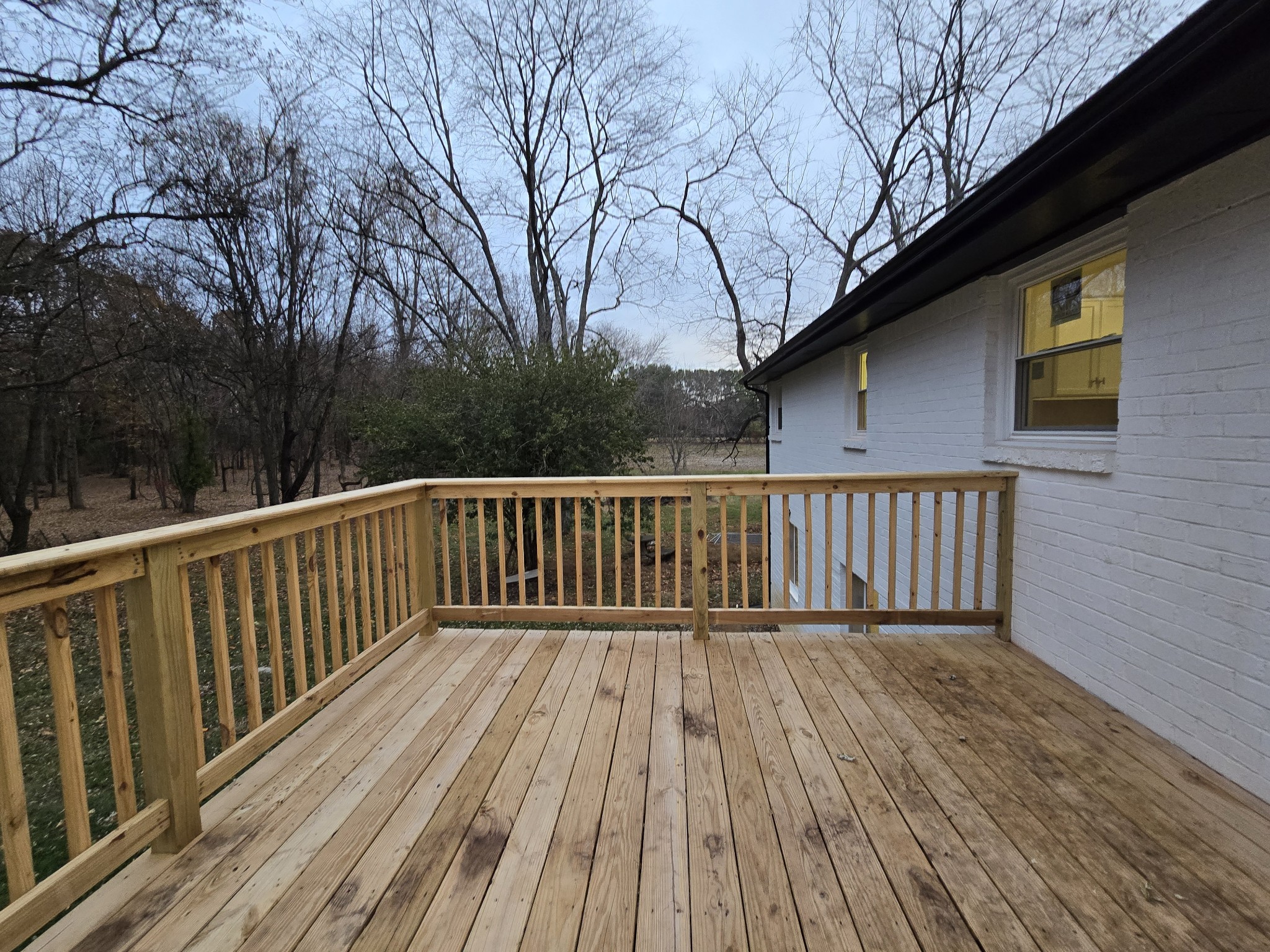 223 Raymond Hodges Road Cottontown, TN 37048 - Photo 11 of 37 a balcony with wooden floor and trees