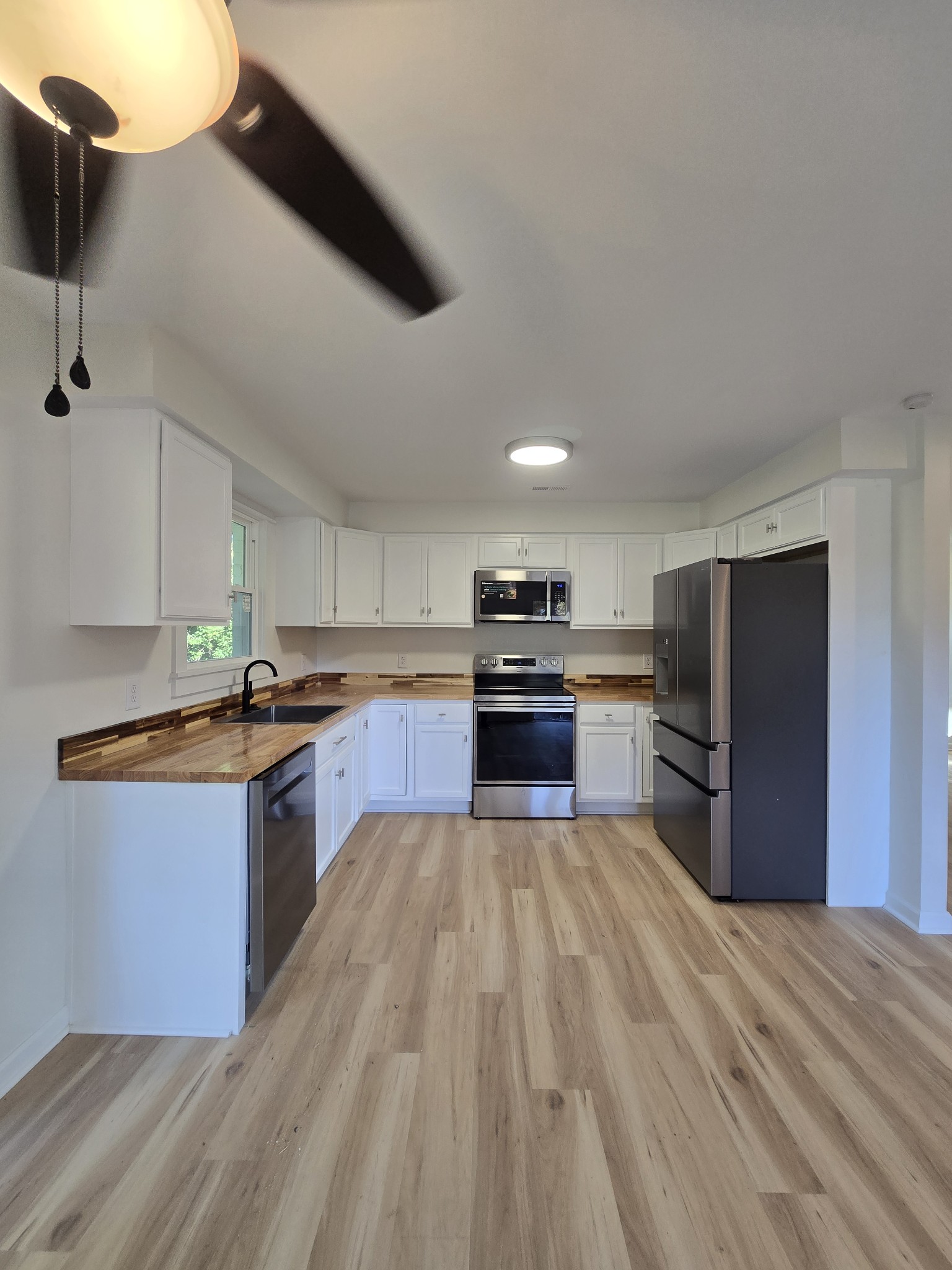 223 Raymond Hodges Road Cottontown, TN 37048 - Photo 13 of 37 a kitchen with stainless steel appliances granite countertop a stove and a refrigerator