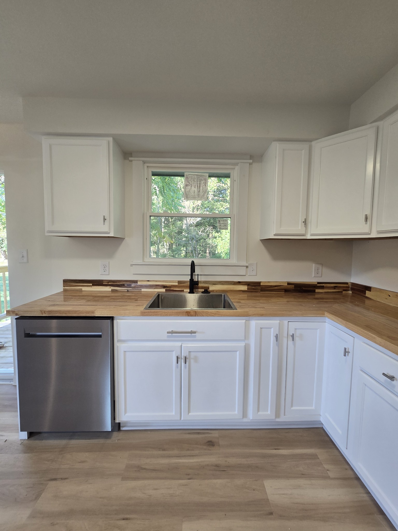 223 Raymond Hodges Road Cottontown, TN 37048 - Photo 14 of 37 a kitchen with stainless steel appliances granite countertop a sink and a stove