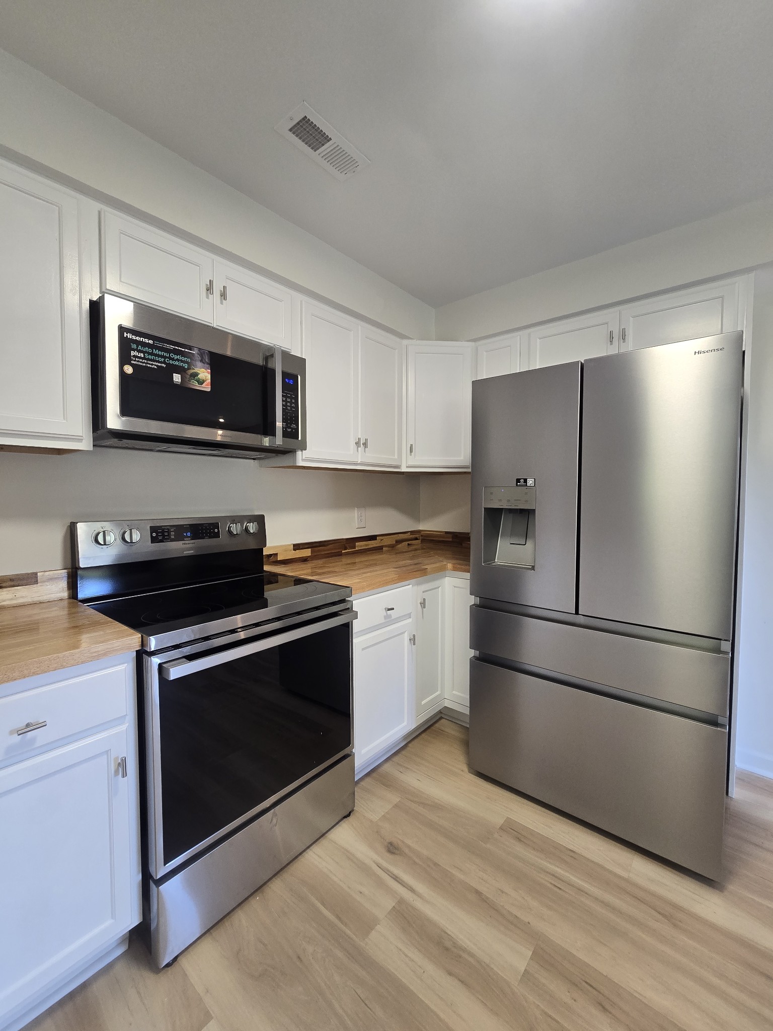 223 Raymond Hodges Road Cottontown, TN 37048 - Photo 16 of 37 a kitchen with a refrigerator stove and microwave