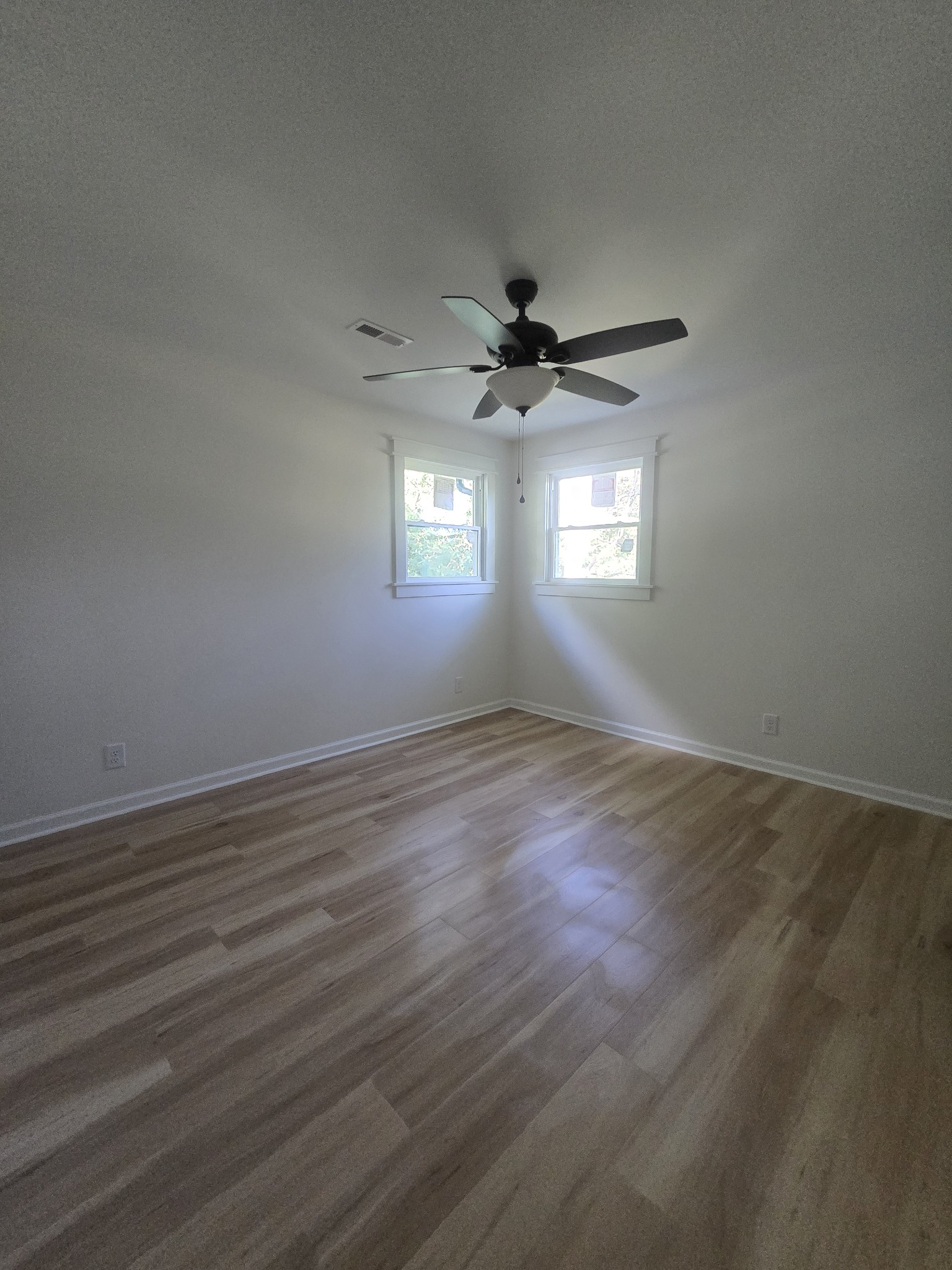 223 Raymond Hodges Road Cottontown, TN 37048 - Photo 17 of 37 an empty room with wooden floor and windows