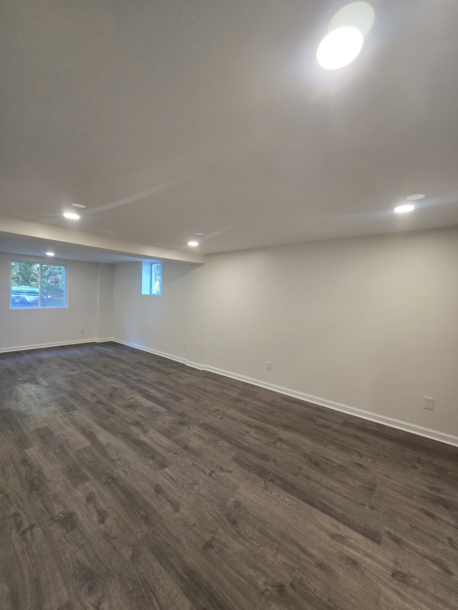 223 Raymond Hodges Road Cottontown, TN 37048 - Photo 35 of 37 an empty room with wooden floor and windows
