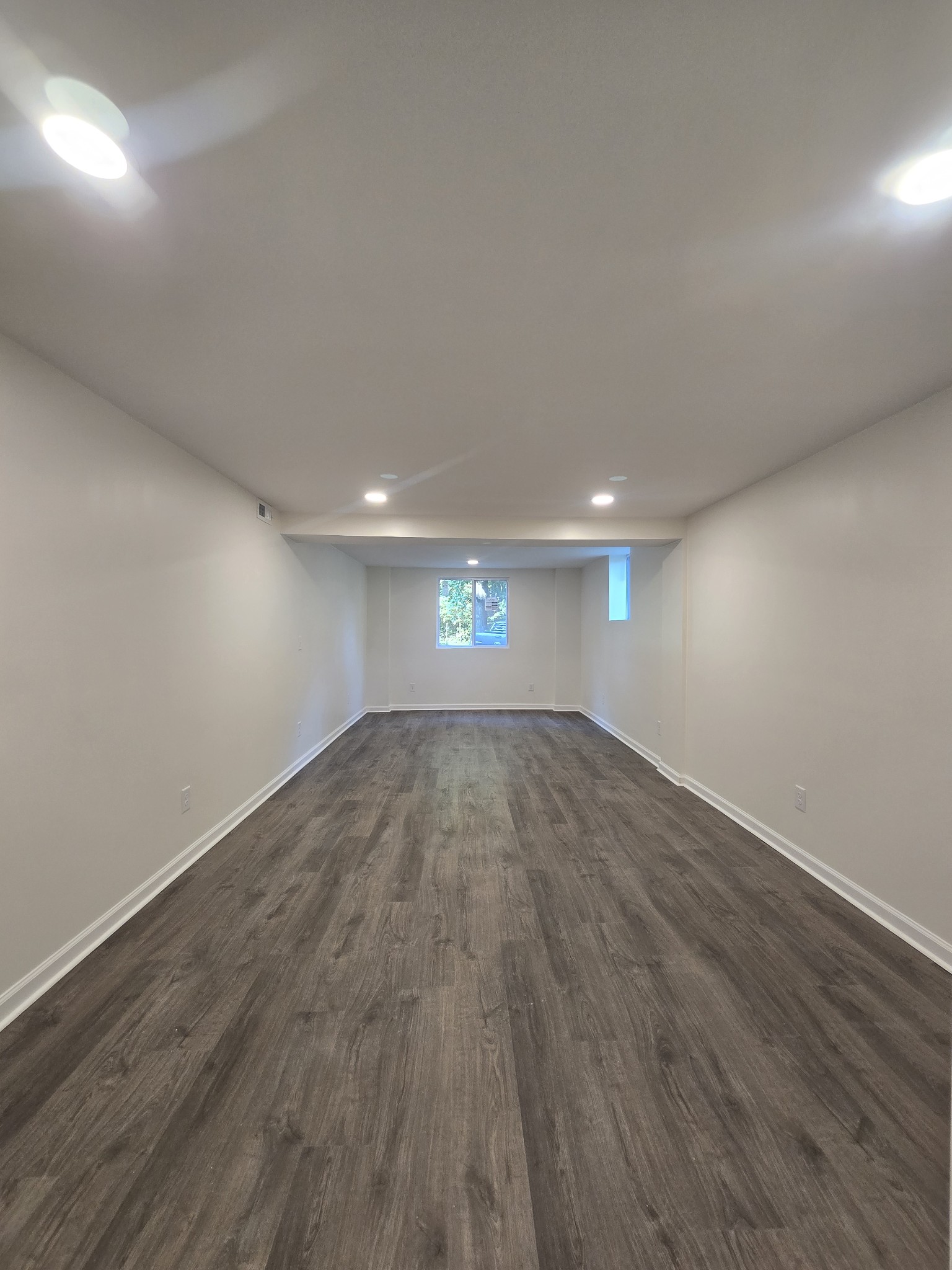 223 Raymond Hodges Road Cottontown, TN 37048 - Photo 36 of 37 an empty room with wooden floor and windows
