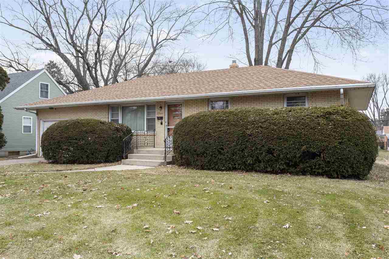 3826 Highcrest Road Rockford, IL 61107 - Photo 1 of 13 a view of a house with a large tree and a yard