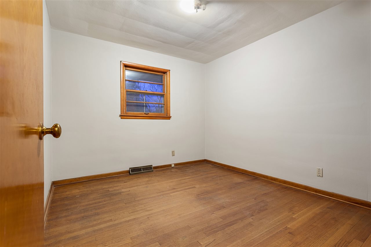 3826 Highcrest Road Rockford, IL 61107 - Photo 13 of 13 an empty room with wooden floor and fan