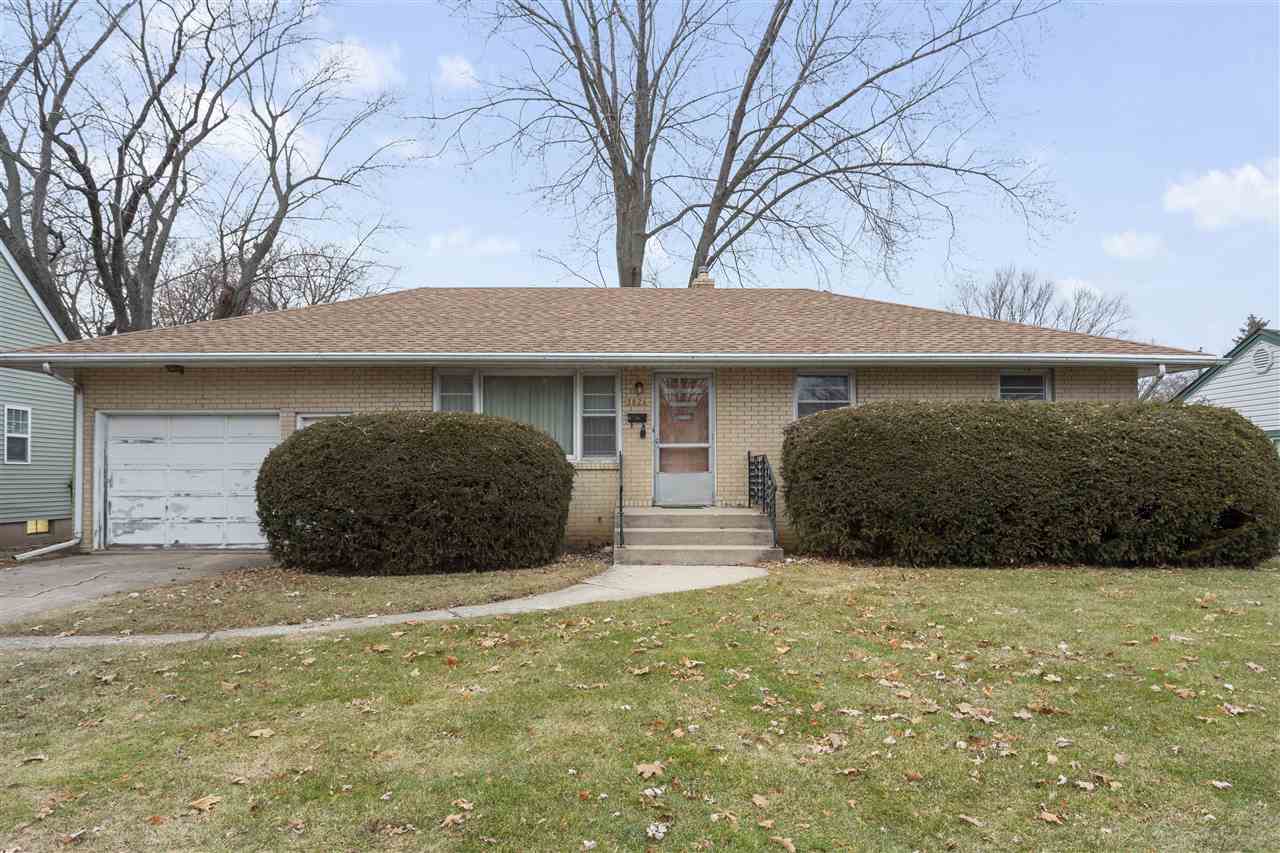 3826 Highcrest Road Rockford, IL 61107 - Photo 2 of 13 a view of a house with a yard and garage