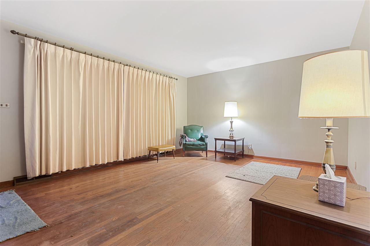 3826 Highcrest Road Rockford, IL 61107 - Photo 8 of 13 a spacious bedroom with a bed and a lamp