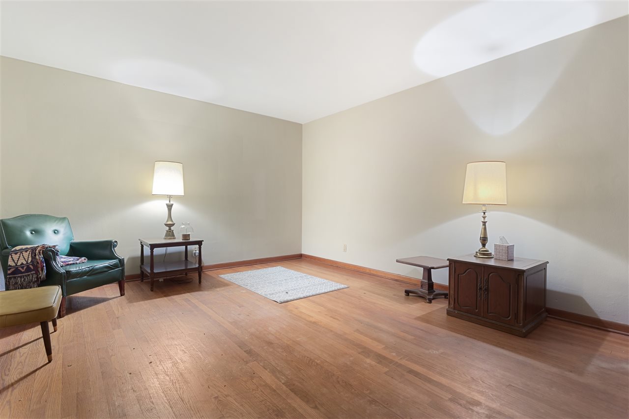3826 Highcrest Road Rockford, IL 61107 - Photo 9 of 13 a bedroom with a bed and a lamp on table