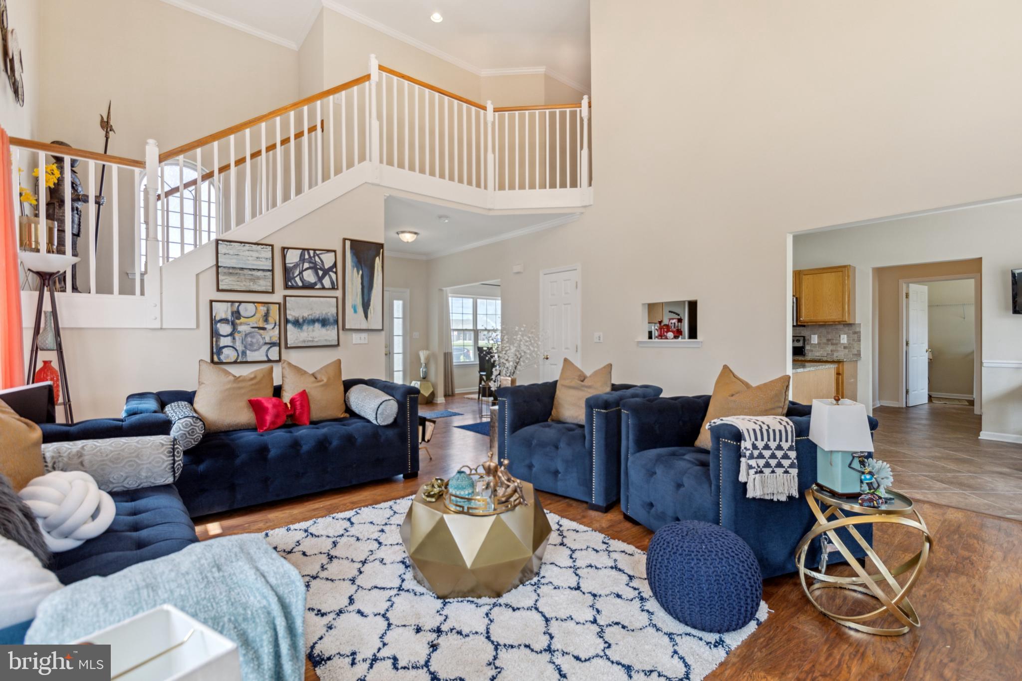 17 Brook Ramble Lane Townsend, DE 19734 - Photo 26 of 35 a living room with furniture a fireplace and a chandelier