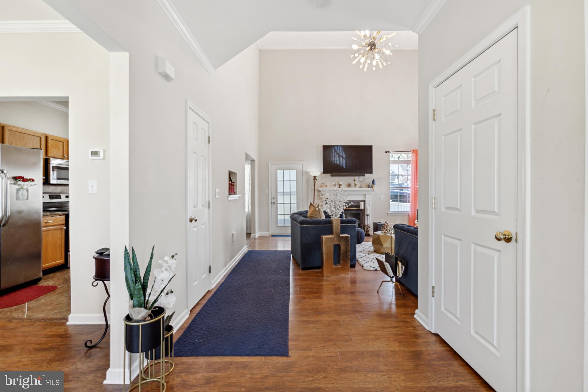 17 Brook Ramble Lane Townsend, DE 19734 - Photo 6 of 35 a view of a livingroom with table and staircase