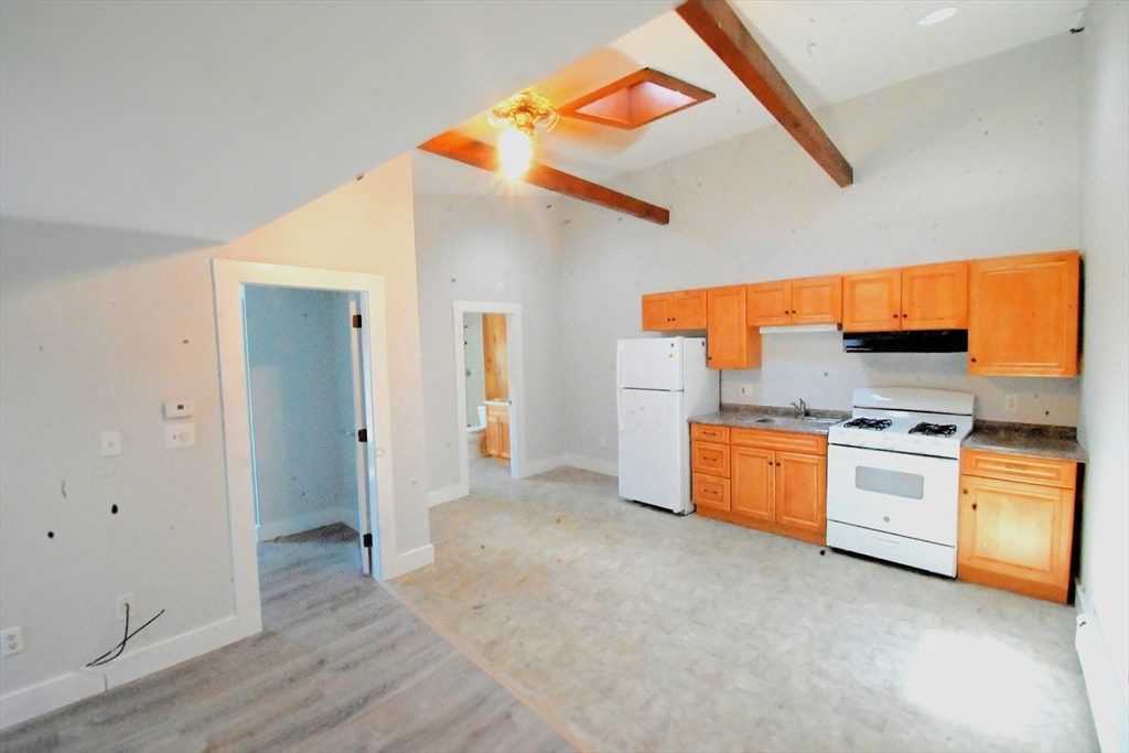 a kitchen with stainless steel appliances a stove and a refrigerator