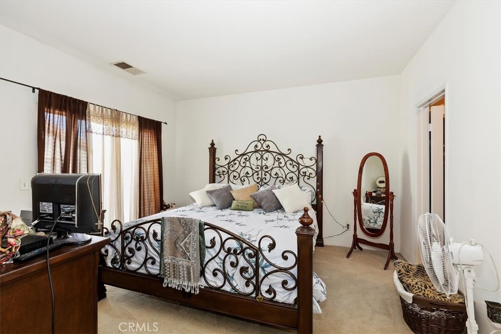 7331 Shelby Place, Unit U140 Rancho Cucamonga, CA 91739 - Photo 13 of 23 a bedroom with a bed and a television