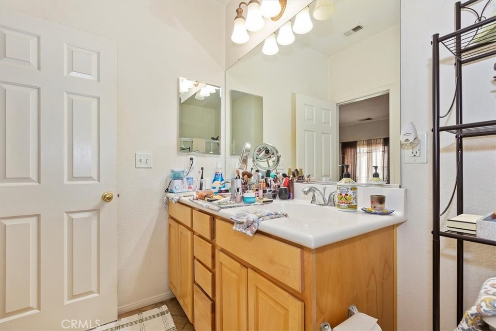 7331 Shelby Place, Unit U140 Rancho Cucamonga, CA 91739 - Photo 17 of 23 a bathroom with a sink vanity and mirror