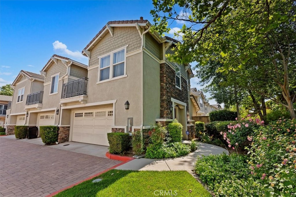 7331 Shelby Place, Unit U140 Rancho Cucamonga, CA 91739 - Photo 22 of 23 a front view of a house with a yard