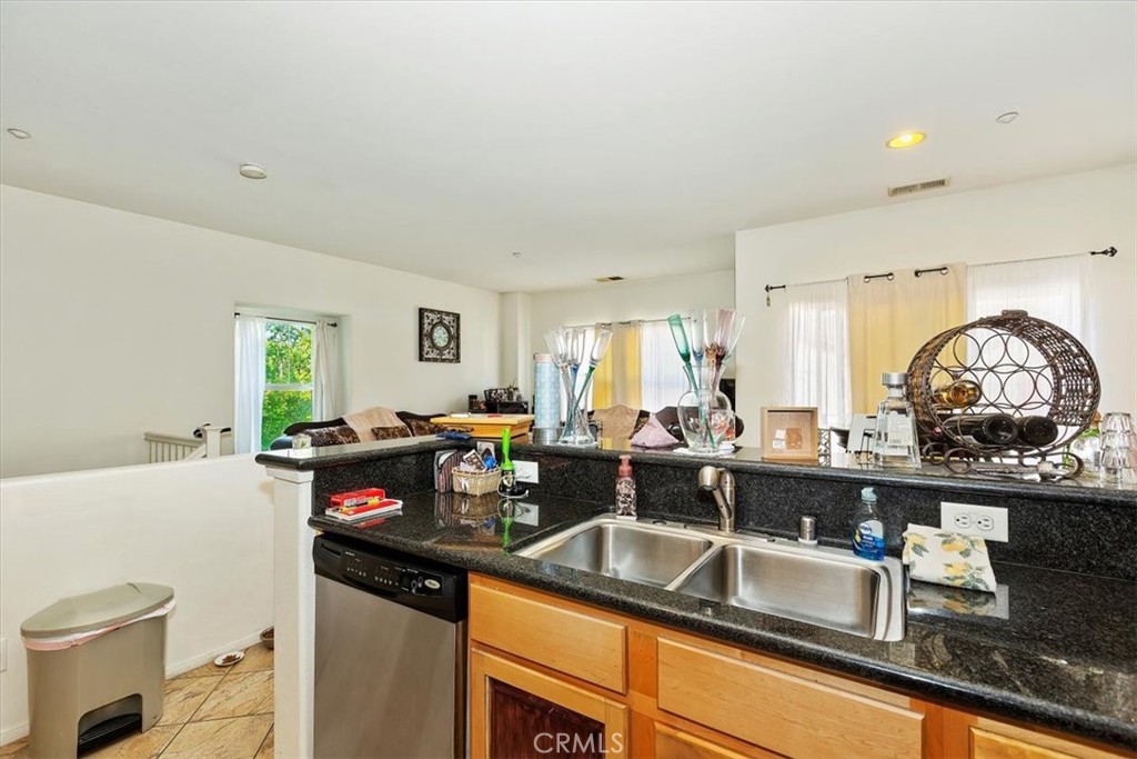 7331 Shelby Place, Unit U140 Rancho Cucamonga, CA 91739 - Photo 7 of 23 a kitchen with a sink a stove and cabinets