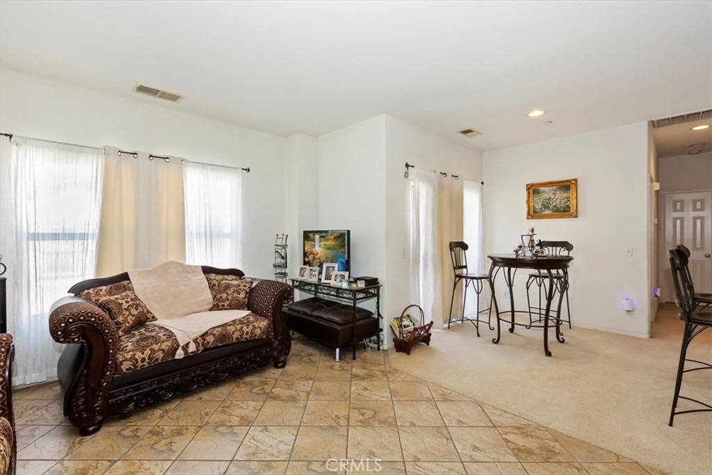7331 Shelby Place, Unit U140 Rancho Cucamonga, CA 91739 - Photo 8 of 23 a living room with furniture and a large window