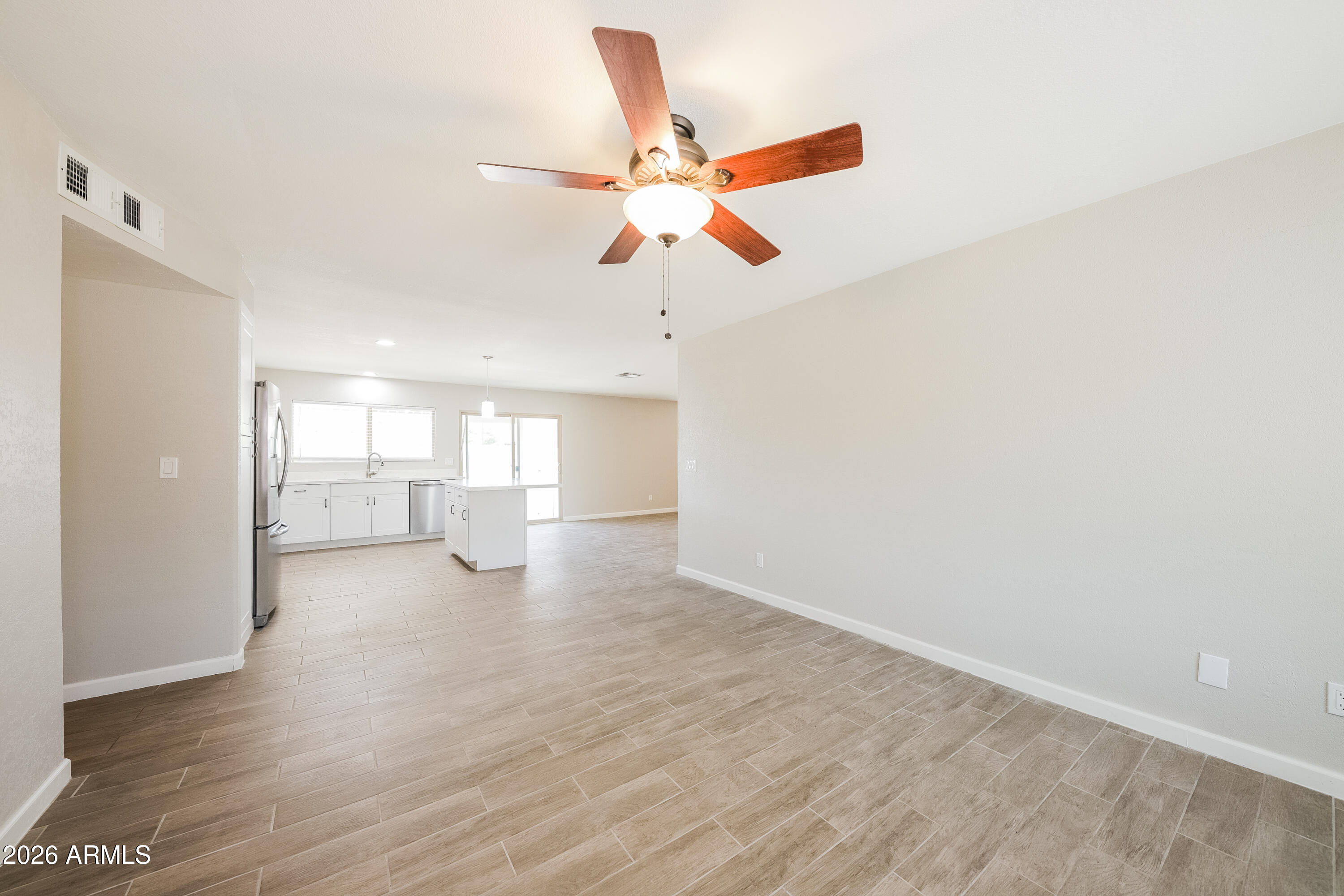 2501 East Villa Rita Drive Phoenix, AZ 85032 - Photo 12 of 15 a view of empty room with wooden floor and fan