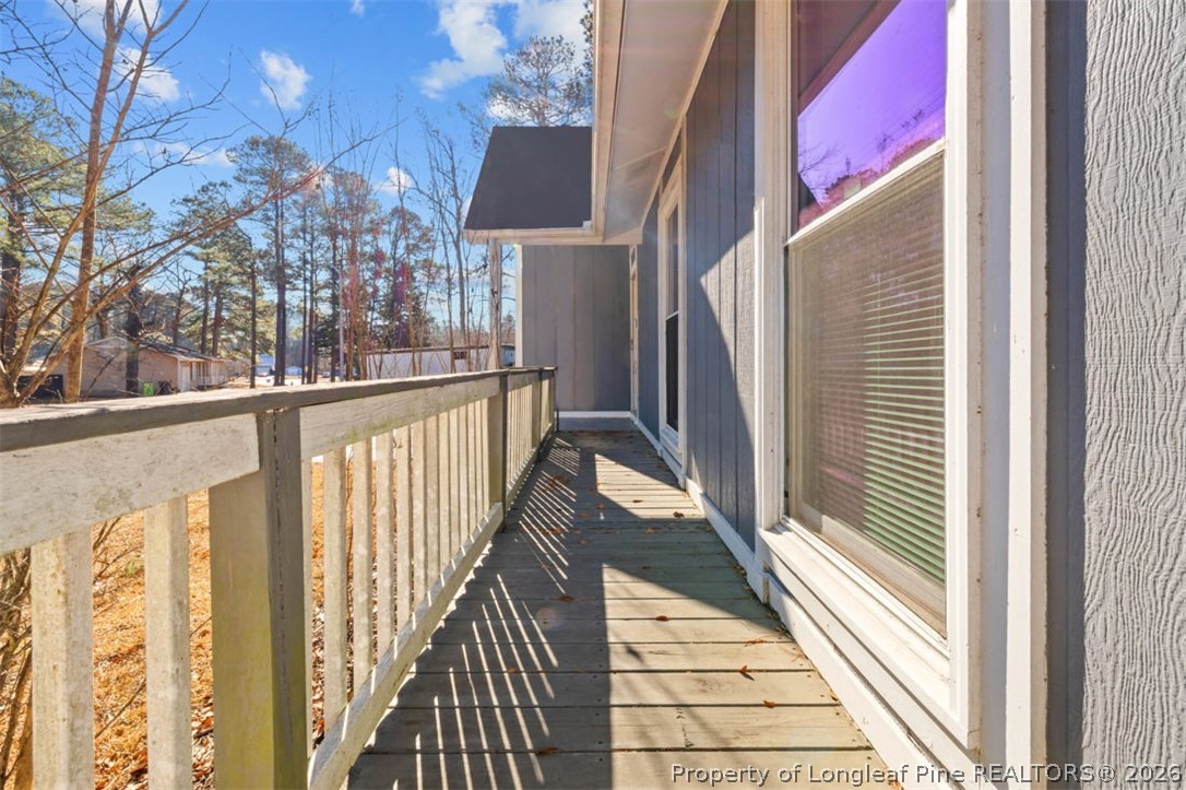 3305 Hunting Bay Drive Spring Lake, NC 28390 - Photo 6 of 27 a view of a balcony with wooden floor and fence