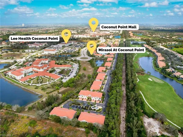 an aerial view of a house with a yard and outdoor seating