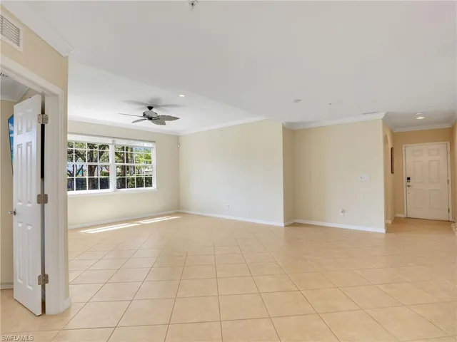 a view of a livingroom with furniture a ceiling fan and kitchen