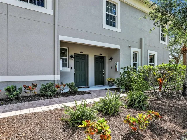 a large kitchen with stainless steel appliances kitchen island granite countertop a refrigerator a stove a sink a microwave and a dining table