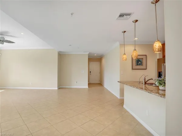 a kitchen with a sink a counter space and a chandelier