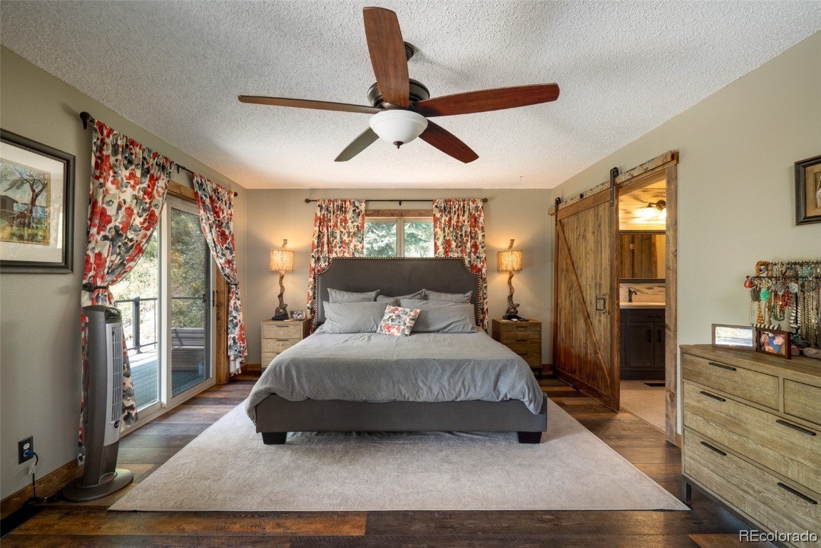 58195 Jupiter Place Clark, CO 80428 - Photo 15 of 29 a bedroom with a large bed and a window