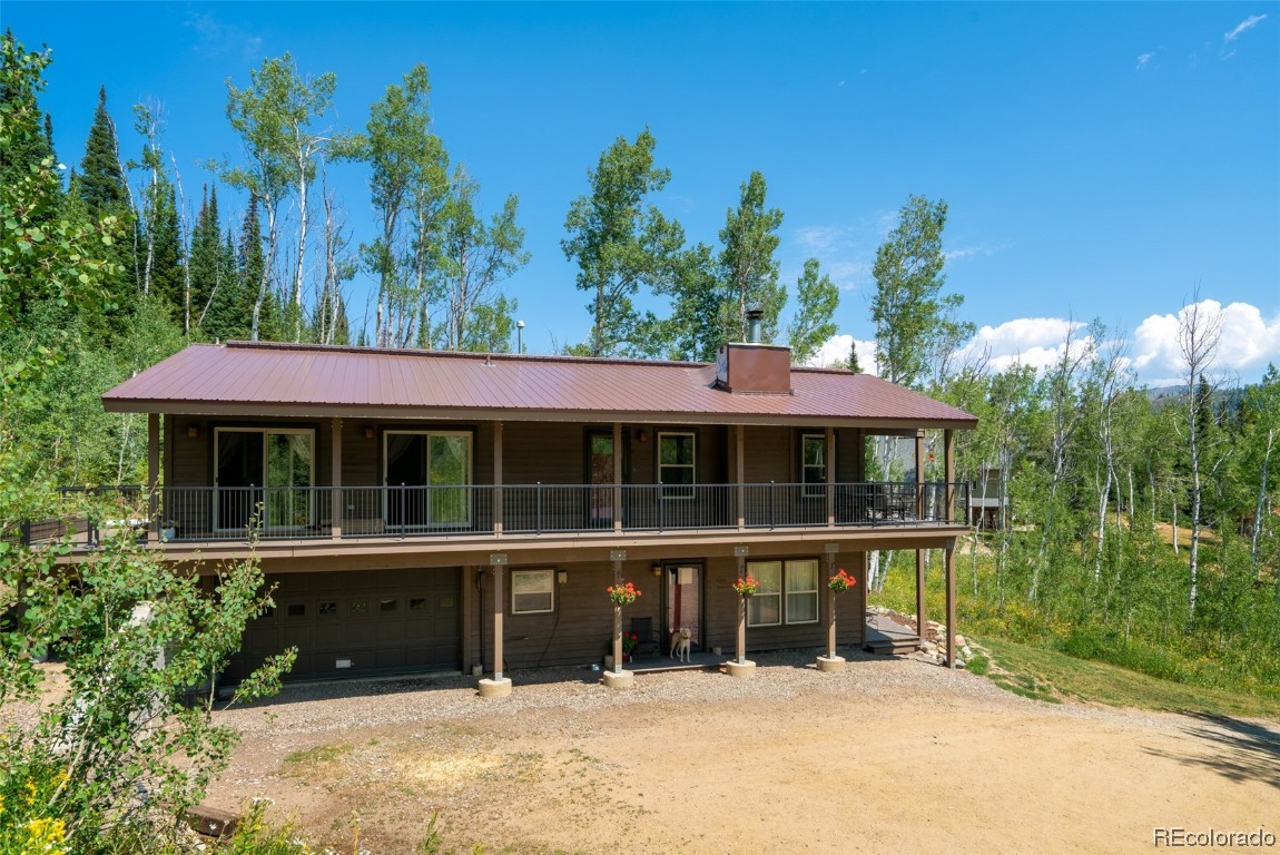 58195 Jupiter Place Clark, CO 80428 - Photo 27 of 29 a view of a house with a garden