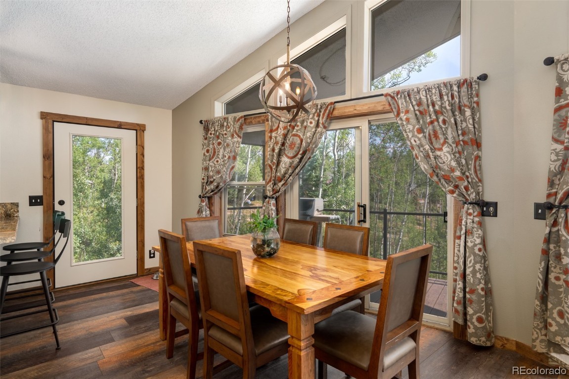 58195 Jupiter Place Clark, CO 80428 - Photo 5 of 29 a view of a dining room with furniture window and wooden floor