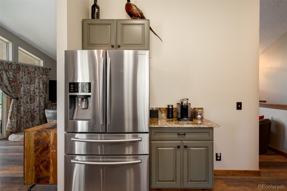 58195 Jupiter Place Clark, CO 80428 - Photo 9 of 29 a kitchen with stainless steel appliances a refrigerator and microwave