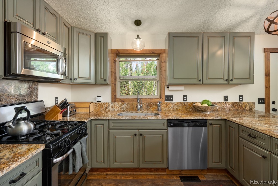 58195 Jupiter Place Clark, CO 80428 - Photo 10 of 29 a kitchen with a sink stove top oven and cabinets