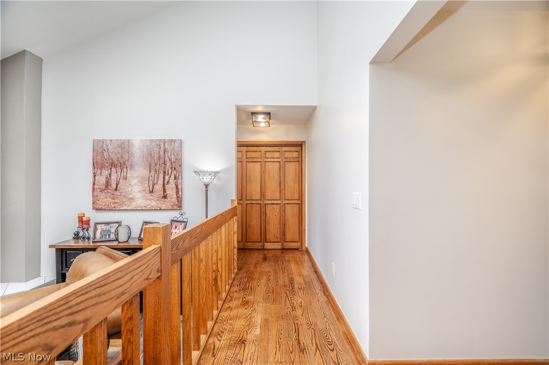 405 Airport Road Northwest Warren, OH 44481 - Photo 30 of 50 Hardwood flooring hallway with a natural wood railing leading to bedrooms.