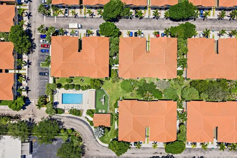 an aerial view of a house with a garden and trees