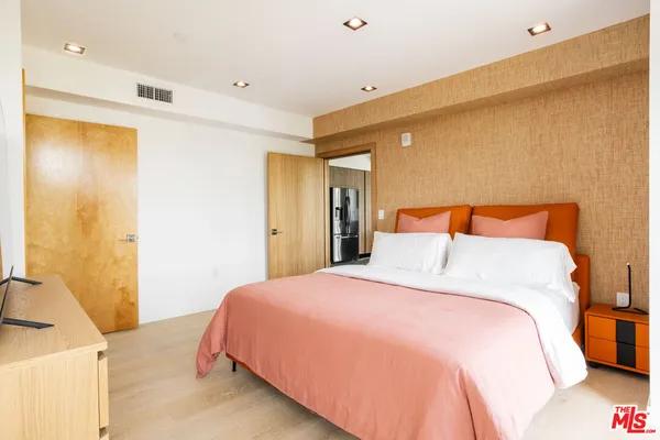 a bedroom with a bed and a dresser