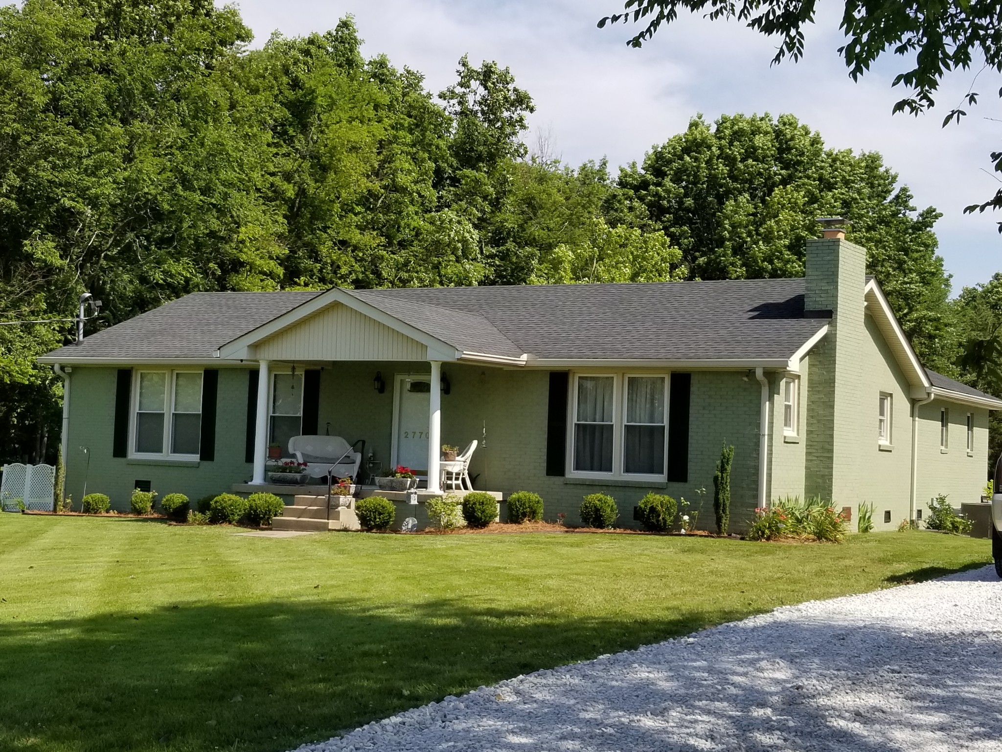 a front view of house with yard and green space