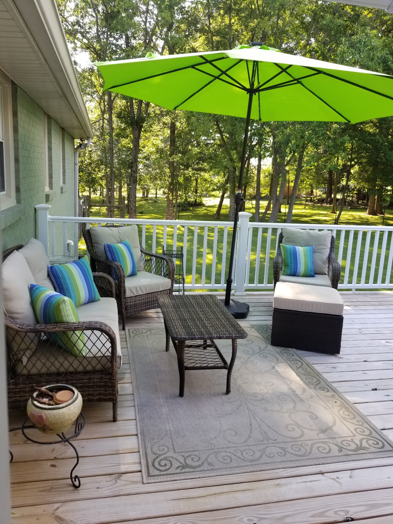 2770 Ben Green Road Lebanon, TN 37090 - Photo 32 of 37 a roof deck with a table and chairs under an umbrella
