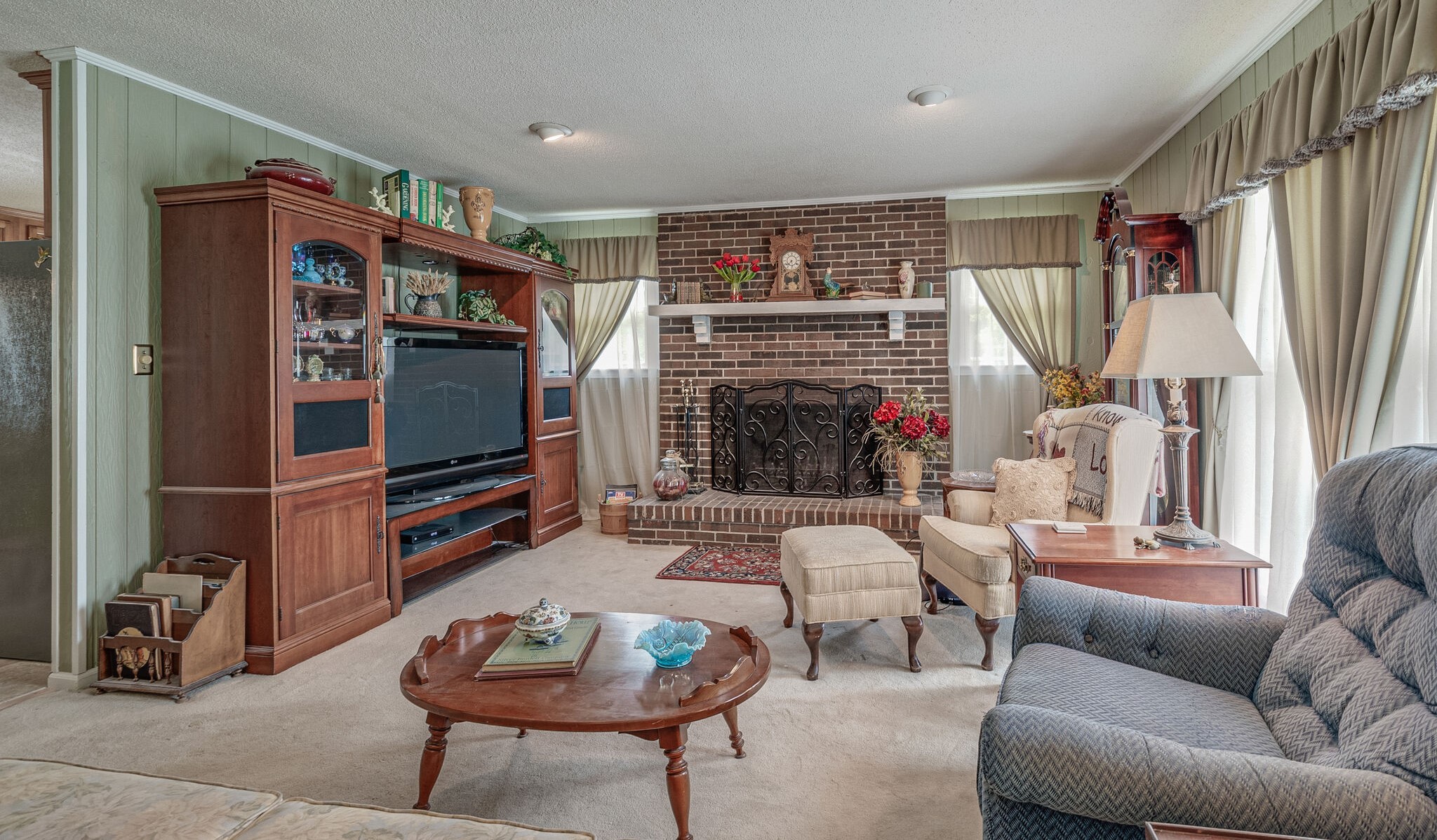 2770 Ben Green Road Lebanon, TN 37090 - Photo 7 of 37 a living room with furniture a flat screen tv and a fireplace