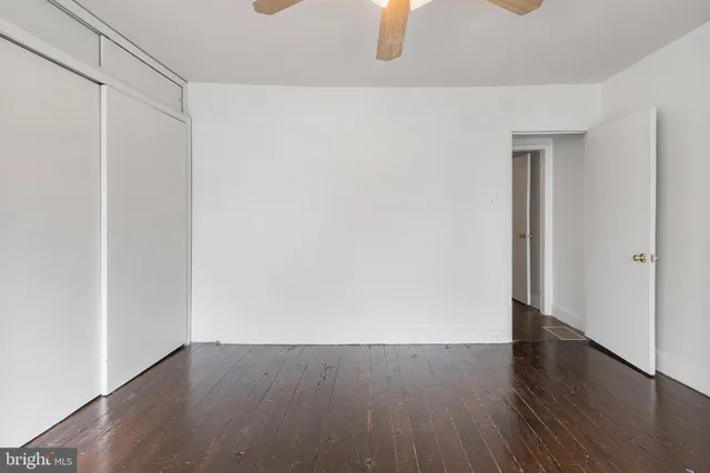 a view of an empty room with wooden floor
