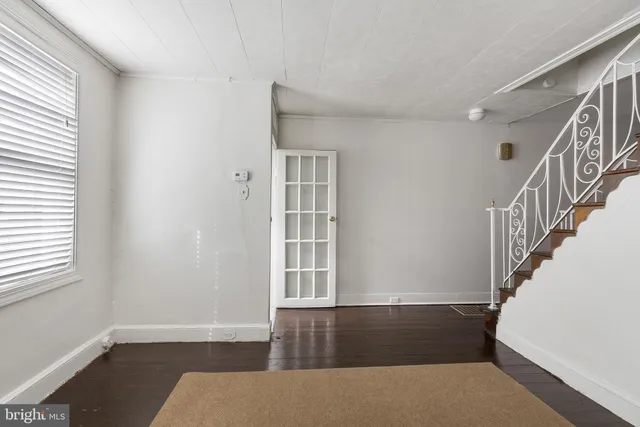 a view of wooden floor and windows in a room