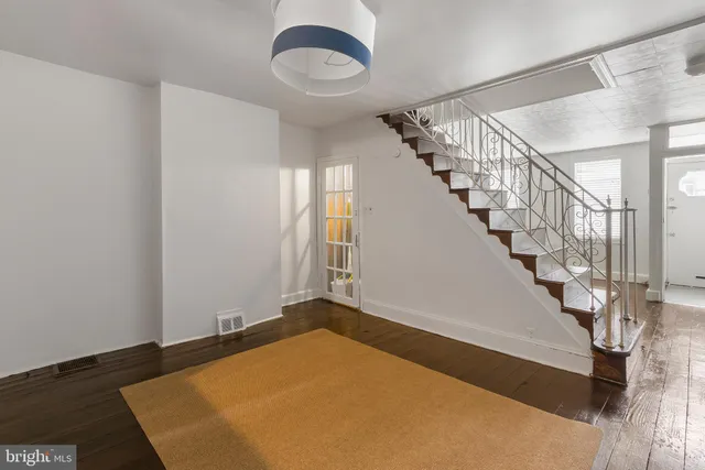 a view of a room with wooden floor and stairs