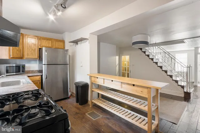 a kitchen with wooden cabinets and a stove top oven