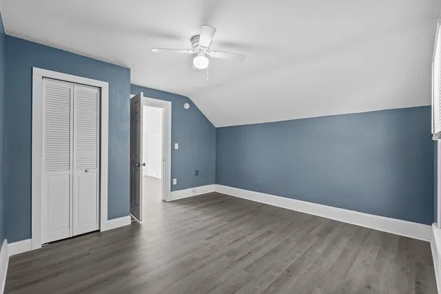 a view of an empty room with wooden floor