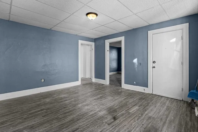 a kitchen with stainless steel appliances granite countertop wooden cabinets a sink and dishwasher with wooden floor