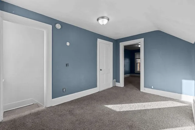 an empty room with closet and bathroom