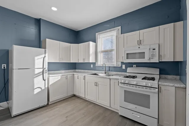 a kitchen with a white cabinets and white appliances