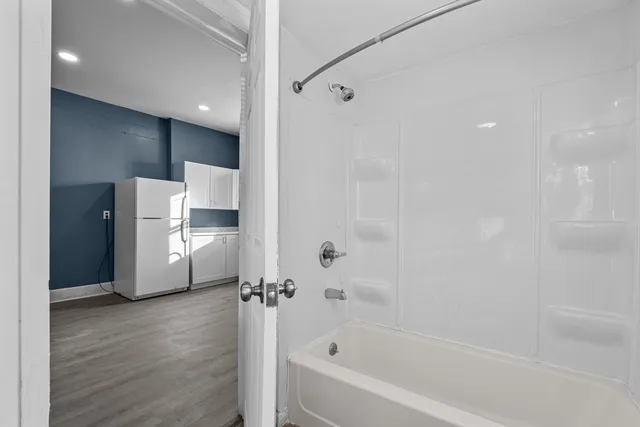a bathroom with a bathtub and a shower